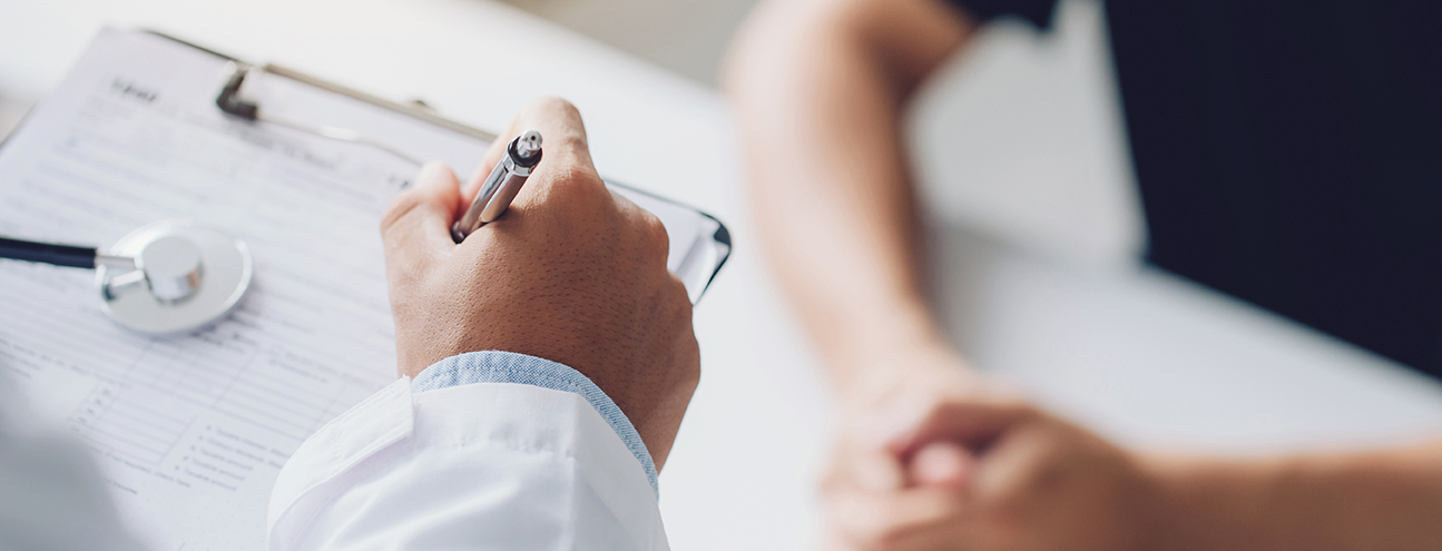 doctor holding test results and consulting patient at desk medic